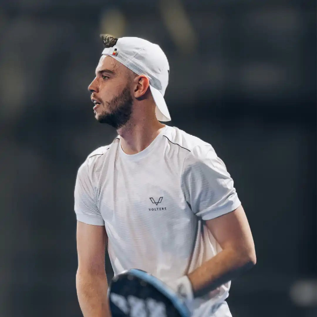 Athletic man wearing a white t-shirt and backwards white cap.