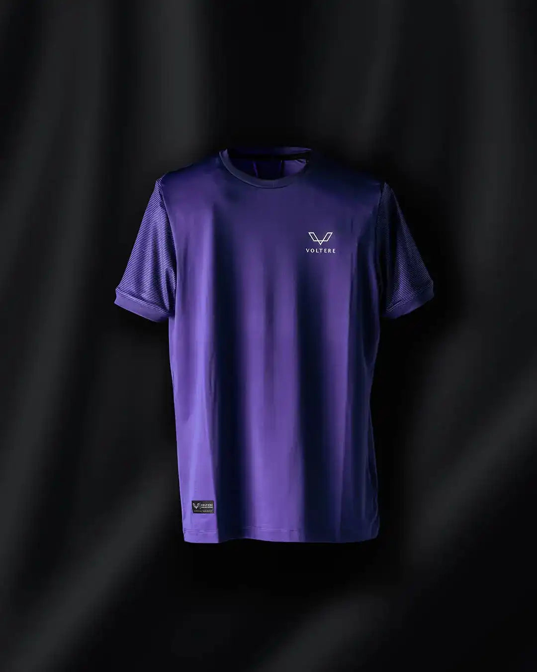 Purple t-shirt with a small logo on the chest.